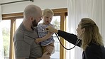 Father, baby and stethoscope of pediatrician for healthcare consultation, check lungs for breathing and heartbeat. Doctor, infant and assessment in clinic or hospital for medical analysis