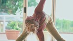 Yoga, exercise and holistic with a flexible woman in her home studio for a wellness or zen workout. Fitness, healthy and balance with a young female yogi training her body for mental heath in a house