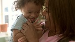 Happy, laughing and mom with baby together with love, bonding and tickle game in home with child, mother and family. Face, smile and mommy relax with girl in funny, laugh or happiness in motherhood
