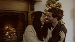 Love, hug or happy couple laughing on Christmas together In celebration of holiday vacation at home. Smile, affection or funny man enjoying bonding time or xmas with a romantic woman by fireplace