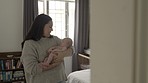 Mother with baby, love and family with bonding for relationship, hug and cuddle child at home. Woman rock newborn to sleep, new mom and affection with care in bedroom