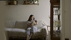 Happy, care and a mother with a baby on the sofa for love, nurturing and comfort. Smile, home and a new mom holding a newborn child for bonding as a parent in the living room together