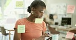 Woman, tablet and sticky note on glass board for planning, brainstorming and marketing strategy or business data. African worker or analyst for digital timeline, startup solution and SEO research