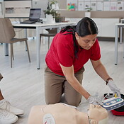 First aid training, people and instructor with demonstration for ...