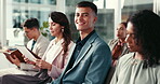 Happy, audience and man in seminar, confident and listening to presentation, notes and smile in workshop. Meeting, trader and training of interns, group and skills for corporate people and team