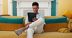 Scroll, relax and tablet with man on sofa for online reading, communication and social media post. Networking update, contact and streaming with person in living room at home for app and search