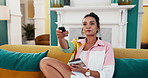 Television, eating and woman with chocolate to relax or taste snack with cocoa flavor and smile in home. Apartment, tv or girl with sweet treat and sugar craving with remote control or cheat meal