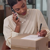 Woman, phone call and logistics for box with writing, label and ...