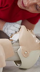Woman, CPR and first aid training with dummy for teaching, listening or helping hand for breathing. Person, coach and paramedic at workshop for employee development with questions for emergency drill