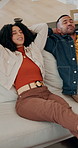 Couple, tired and relax on sofa with smile, love and care with connection in living room at apartment. People, man and woman with eyes closed, talking and happy for rest on couch in lounge at house
