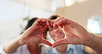 Frame, heart hands and portrait of couple in home together for bonding, love or romance on valentines day. Emoji, shape and smile of man with woman in living room of apartment for dating or marriage