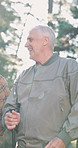 Hiking, laughing and talking with senior man outdoor in forest for exercise, hobby or recreation. Adventure, conversation and funny with old person in nature for activity, fitness or wilderness hike