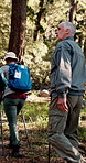 Senior people, fitness and hiking in nature with tools, wellness and journey in retirement. Elderly group, friends or trekking in forest for bird watching, outdoor activity or exploring for discovery