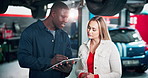 Woman, mechanic and talking on tablet at garage of car repairs, vehicle inspection and maintenance. Artisan, client and digital with diagnostic software for service manual, ordering parts and updates
