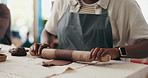 Clay, rolling pin and man in pottery class for handcraft, sculpture or manufacturing product. Artistic, creative and hands of person with ceramic skill for molding shape with mud material in workshop