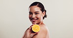 Happy woman, orange or face in studio for skincare, natural treatment or vitamin C. Girl, citrus fruit or smile on white background space for organic care, healthy skin or antioxidants for protection