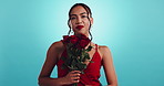 Smell, flowers and face of woman in studio with smile, happy celebration or valentines day gift. Red roses, romantic offer and female person with bouquet, floral present or love on blue background