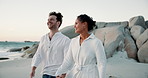 Couple, walking and holding hands at beach outdoor of summer vacation, bonding together and travel. People, journey and support at ocean of holiday getaway, relationship commitment and adventure trip
