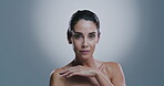 Confidence, woman and face in studio for skincare, dermatology and wellness with self care by mockup space. Portrait, mature person and touch with beauty for cosmetics, anti aging and gray background