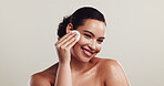 Skincare, face and woman with cotton, studio and smile for cleansing with exfoliation, happy and space. White background, beauty and dermatology for healthy skin, cosmetics and person with product