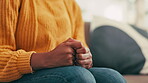 Anxiety, hands and nervous tick of woman on sofa in living room of home with coping mechanism.  Psychology, stress or worry and bipolar person closeup in apartment with symptoms or schizophrenia