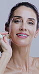 Face, jade roller and smile with mature woman in studio for morning cosmetics or skincare routine. Antiaging, massage and relax with happy person on white background for beauty or dermatology