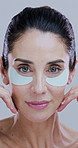 Collagen, woman and face with eye patches in studio for hydration, smooth skin results and wrinkles reduction. Beauty, person and cosmetics for dark circles, self care or skincare on white background