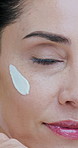 Cream, skincare and face of mature woman for beauty, wellness and facial care on white background. Dermatology, spa and portrait of person for anti aging, collagen and cosmetics products in studio