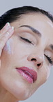 Face cream, beauty and mature woman in studio for skincare, wellness and facial care on white background. Dermatology, lotion and portrait of person for anti aging, collagen and cosmetics products