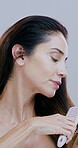 Wellness, beauty and woman brush hair on studio background for scalp stimulation and growth benefits. Person, cosmetic product and styling for grooming routine, smooth and collagen treatment result