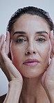 Woman, face and dermatology in studio for skincare, treatment and collagen benefits for anti aging. Portrait, beauty model and mature person with confidence for cosmetics, glowing or white background