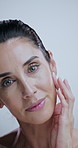 Mature woman, skincare and results in studio with face, check and process for beauty by background. Person, model and smooth in portrait for cosmetics, glow and anti aging transformation in Greece