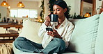 Phone, coffee and woman in home for relax, reading blog and check message on social media. Morning, drink and girl on mobile for online communication, chat app and download ebook on internet on sofa