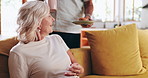 Senior woman, man and reading book with coffee, surprise and muffin in living room in retirement. Couple, care and tea with dessert, literature and relax on couch with love in lounge at apartment