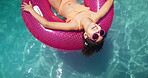 Girl, donut and child floating in pool, freedom and summer break for peace on vacation. Plastic toy, inflatable support and person chilling on holiday trip, sunglasses and hotel resort to relax