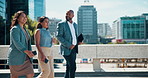 Outdoor, walking and business people with teamwork, travel and commute with cooperation. New York, group or employees in urban town, schedule or buildings with collaboration, development or chatting