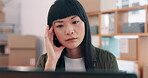 Laptop, logistics and stress with Asian woman in office for management of delivery or distribution schedule. Box, computer and ecommerce with employee in supply chain depot for backlog or delay