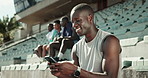 Fitness, smile and man with cellphone, stadium and internet for social media, texting and email. Person, runner and athlete with smartphone, sports and mobile app with break, relax and connection