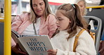 Travel, book and mom with child on bus reading together for entertainment, bonding and connection. Happy, fantasy and girl kid with mother for storytelling with commuting on public transport together