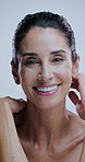 Mature woman, skincare and face in studio with beauty, thinking and happy for results by background. Person, model and smile in portrait for cosmetics, glow and anti aging transformation in Greece