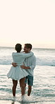 Playing, hug or happy couple in water at beach for valentines day or love in interracial relationship. Dancing, splash or people bonding at sea on holiday for romantic honeymoon, vacation and date