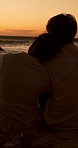 View, sunset or back of couple at beach for valentines day, love or vacation in interracial relationship. Relax, chill or people hug for bonding on holiday for romantic honeymoon, care or travel date