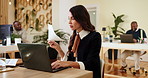 Business woman, laptop and documents with information for data entry, checklist or process at agency. Female person, travel agent or employee with paperwork on computer for schedule or booking trip