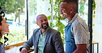 Business, people and talking to waiter in cafe for order assistance, customer service and helping. Professional, employees and barista with menu questions, lunch break and hospitality in coffee shop