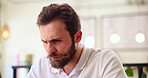 Cafe, stress and man with laptop, reading and unhappy with criticism of ebook, writer and browsing. Creative, remote work and person with tech in coffee shop, author and thinking of bad review on web