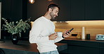 Phone, coffee and man in kitchen in morning at home reading online blog for world news report. Cappuccino, cellphone and male person drinking caffeine latte with politics tabloids in apartment.