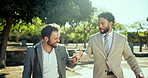 Happy, businessmen and walking with handshake for greeting, farewell or morrning commute to work. Male people, friends or employees shaking hands or fist bump for start, job or motivation at park