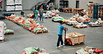 People, volunteering and food for distribution at warehouse, community charity and humanitarian crises. Staff, machine and grocery stock with courier services, homeless donation and parcel logistics