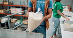 Hands, food drive and teamwork with volunteer people packing donations for community outreach. Aid, charity and social responsibility with non profit group organizing oats for foundation contribution