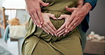 Pregnant, stomach and couple with heart hands for love, maternal or prenatal care in family home. Pregnancy, woman and man touch body for support, romance or health for future parents in baby nursery